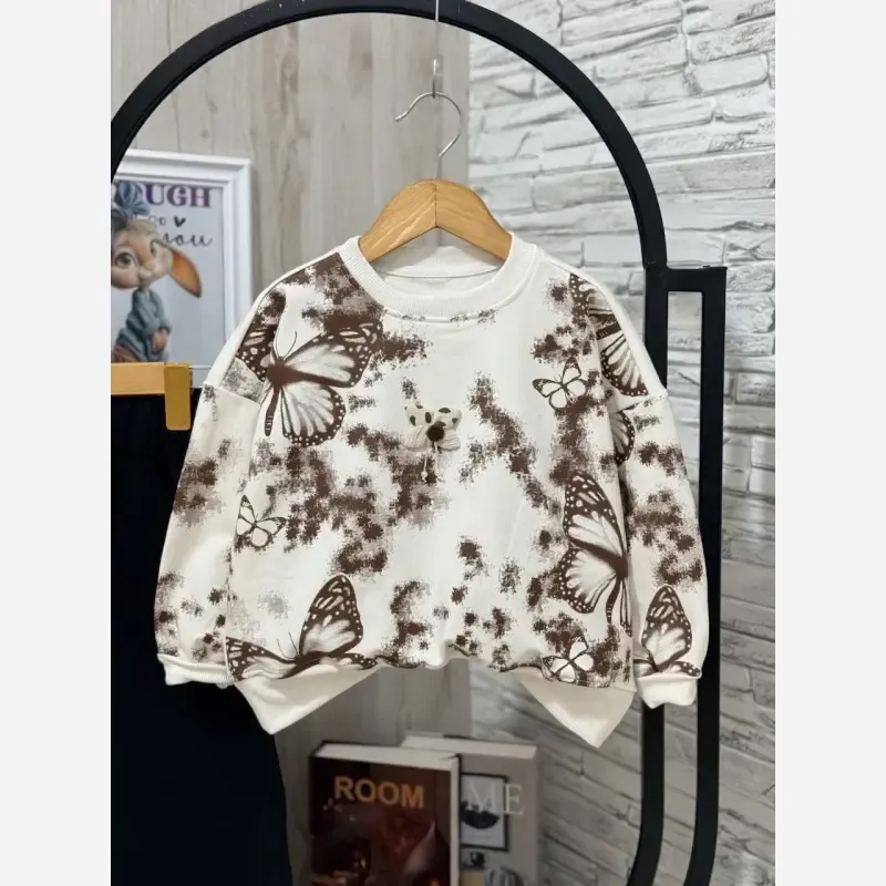 ست لباس دخترانه بلوز و شلوار دورس طرح پروانه رنگ سفید کرم شکلاتی سایز 45 تا 65 - تصویر 6